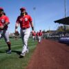 Cincinnati Reds minor league outfielder Quincy McAfee, left, and catcher Garrett Wolforth walks to the dugout before a spring training game against the Chicago Cubs, Monday, March 21, 2022, at Sloan Park in Mesa, Ariz. Cincinnati Reds At Chicago Cubs March 21 0136