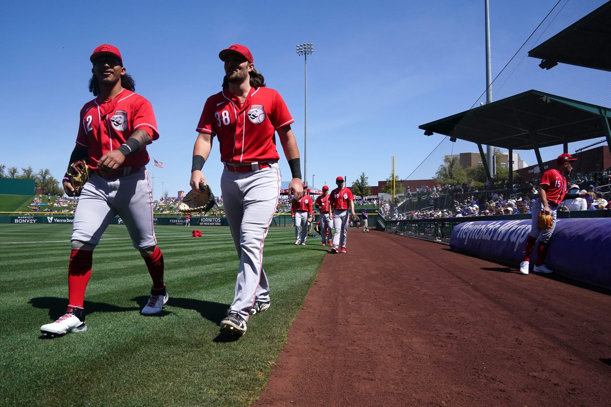 Cincinnati Reds minor league outfielder Quincy McAfee, left, and catcher Garrett Wolforth walks to the dugout before a spring training game against the Chicago Cubs, Monday, March 21, 2022, at Sloan Park in Mesa, Ariz. Cincinnati Reds At Chicago Cubs March 21 0136